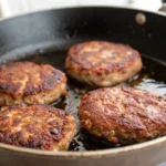 Sizzling breakfast sausage in a skillet